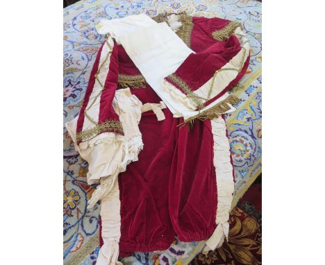 A 19th century reproduction children’s costume of a 17th century gentleman, with red velvet jacket and breeches with gilt and