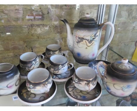 A Japanese tea set with a teapot cups, 5 teacups, 6 saucers, a milk jug and a lidded sugar bowl, see images for details 