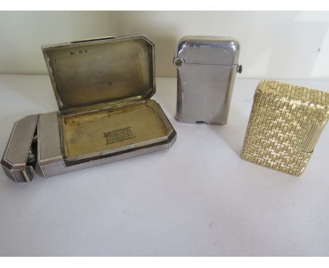 A silver cased lighter with opening side compartment featuring retailers name Theodore Hamblin London, approximately 3.2toz t