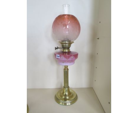 A brass oil lamp with coloured glass font and etched shade - 68cm tall, in good clean condition 