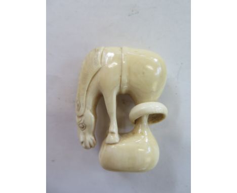 A 19th Century ivory Netsuke horse and ring, unsigned - 5cm x 3.5cm - in good condition 