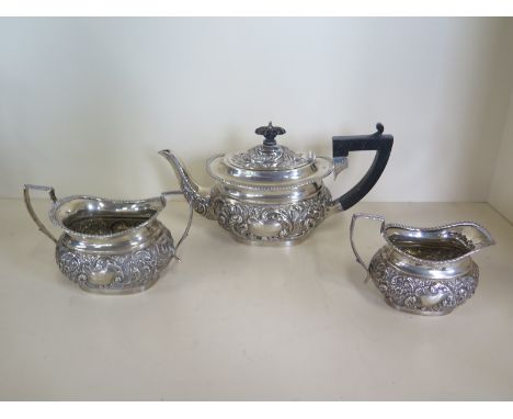 A silver three piece tea set with embossed decoration - Birmingham 1898/99, maker TH, total weight approx 19.5 troy oz - cond