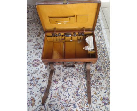 A Vintage Asprey leather suitcase with fittings of silver top bottles, general usage wear, break to handle 
