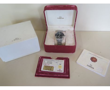 A gents Omega Seamaster 2002 model with a black dial and medium sized stainless steal strap - serial number 8021 9099 with th