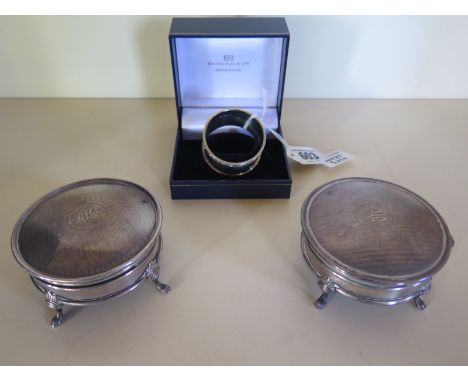 Two silver trinket boxes with quadroform bases with engraved monograms to both of the hinged lids together with a silver napk