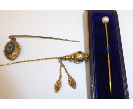 A pearl set Stick Pin, cased and two other stick pins. 