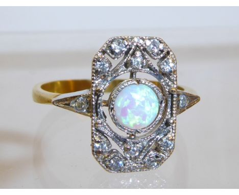 A silver gilt Dress Ring set with a centre opal in Art Deco design surround.