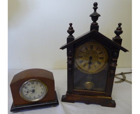 A German Mantel Clock in arched stained pine case and one other mantel timepiece. 