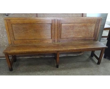 A pair of oak Bench Seats with raised panel backs and book rest.  Each 6' 8" (203cms) wide. 