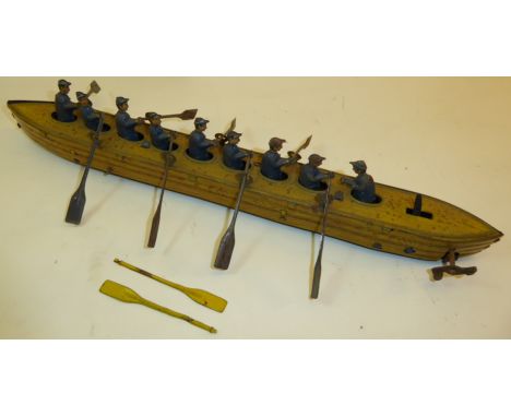 An early 20th Century German tin plate clockwork Model of a Rowing Eight with cox in blue and yellow livery, probably Gunther
