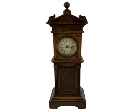 Early 20th century miniature longcase clock, dial bearing Roman Numerals, the case with arched pediment, and carved panel to 