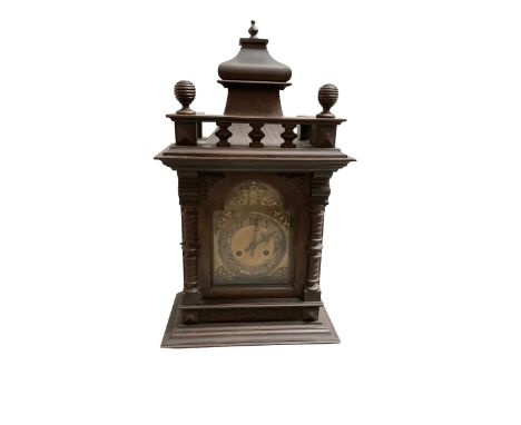 German - Edwardian oak cased 8-day mantle clock, with a raised pediment and gallery, break arch door with attached pilasters,