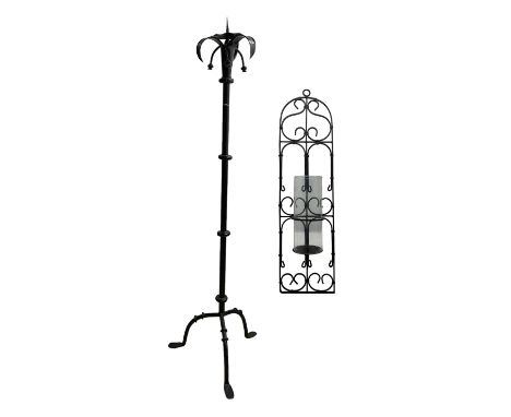 Vintage black painted wrought iron candlestand on tripod feet, H138cm, together with a similar style wirework wall sconce (2)