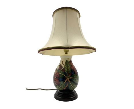 Moorcroft table lamp decorated in the 'Simeon' pattern by Philip Gibson, of baluster form on turned ebonised base, with shade