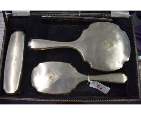 A cased four piece silver engine turned dressing table set,&nbsp;by&nbsp;S&nbsp;Blanckensee &amp; Son Ltd,&nbsp;Birmingham 19