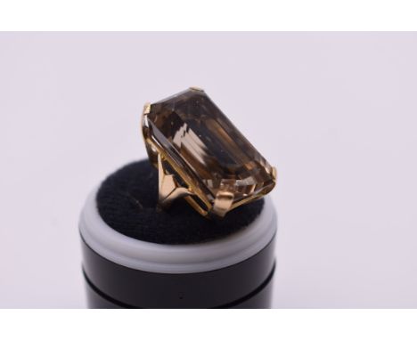 A large casket cut smoky quartz cocktail ring, stamped 9ct, 13.8g total weight. 