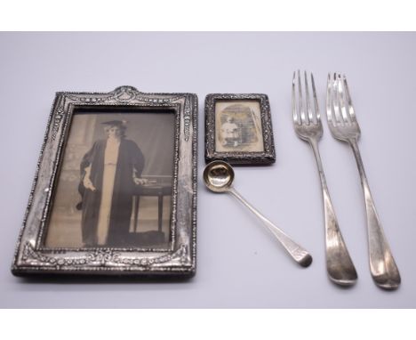 An Edwardian silver rectangular photograph frame, by Green &amp; Cadbury Ltd, Birmingham 1907, 18 x 12cm; together with a sma