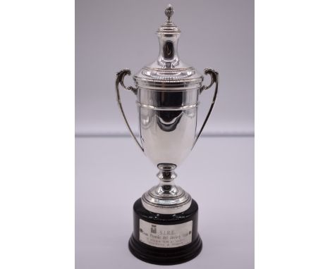 An Italian white metal twin handled lidded trophy cup and cover, by R Miracoli, stamped 800, on wood socle, 17cm total height