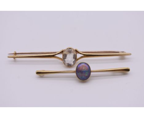 An oval opal bar brooch, stamped 15ct, 5.5cm, 4g; together with another yellow metal bar brooch, set white stone, marks indis