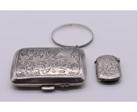 A small group of silver items, comprising: a cigarette case, by John Henry Wynn, Birmingham 1929; a vesta case; and a child's