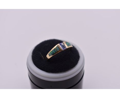 A tanzanite and opal ring, stamped '14k Kabana'. 