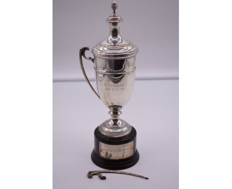 An Italian white metal twin handled trophy cup and cover, by R Miracoli, stamped 800, on wood socle, 17cm total height, (a/f)