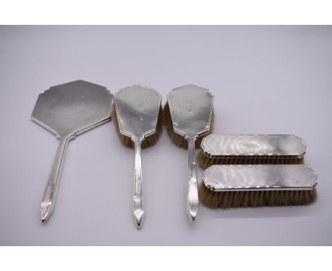 An engine turned silver three piece dressing table set, by&nbsp;S J R London 1956/7; together with a similar pair of brushes,