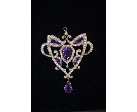 An Art Nouveau amethyst and diamond pendant,&nbsp;the unusually cut amethysts sinuously surrounded with millegrain set diamon