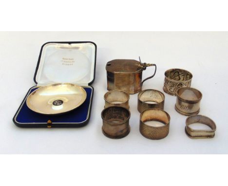 A quantity of hallmarked silver and white metal to include a mustard pot, six napkin rings, a white metal dish in fitted case