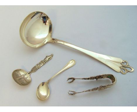 A Danish white metal soup ladle with pierced terminal, a white metal caddy spoon, a pair of white metal sugar tongs, and a wh