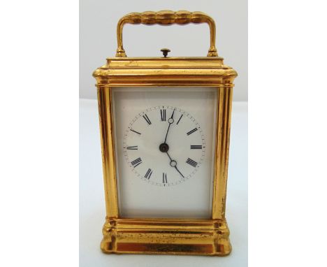 A gilt metal repeating carriage clock, white enamel dial with Roman numerals, 14 x 7.5 x 6cm