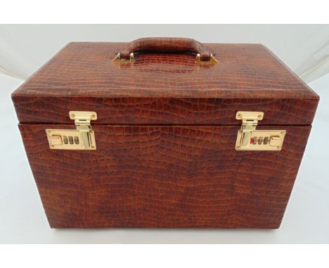 A simulated crocodile skin rectangular travel jewellery casket, the hinged cover revealing a fitted interior with pull out dr