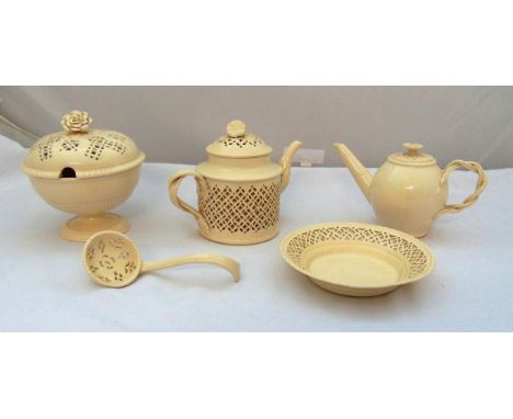 A quantity of Leeds ware cream pottery to include teapots, a sugar bowl and cover, a sifter spoon and a dish (5)