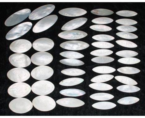 Collection of Chinese mother of pearl gaming counters, oval/elliptical, of varied pattern, some with griffin, some with pagod
