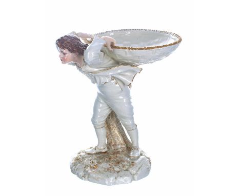 Royal Worcester James Hadley design figural bonbon dish, modelled as a boy with basket upon his back, upon a naturalistic gil