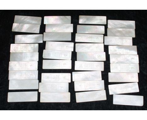 Collection of thirty six Chinese mother of pearl gaming counters, rectangular, each with central griffin within floral border