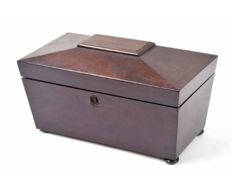 Victorian mahogany sarcophagus tea caddy, the hinged cover enclosing a divided interior with sympathetic later cut glass jar 