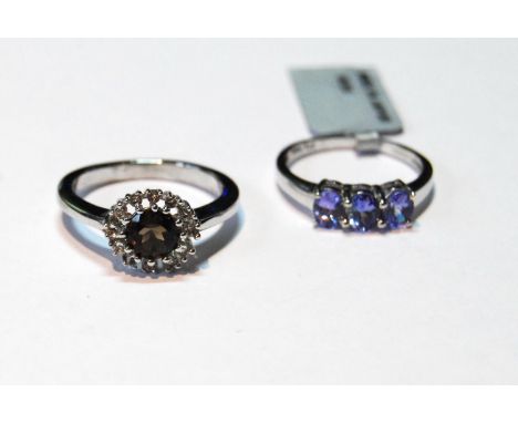 Tanzanite three-stone ring and another, smoky quartz, in 9ct white gold, sizes N and P.&nbsp; &nbsp;(2) 