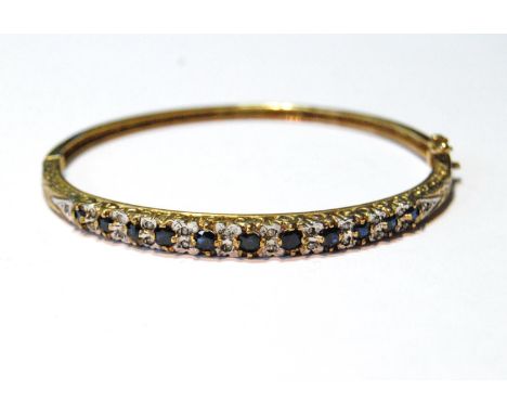 9ct gold hinged bangle with diamonds and sapphires, 11.9g.CONDITION REPORT: Approximately 18cm circumference.  Internal size 