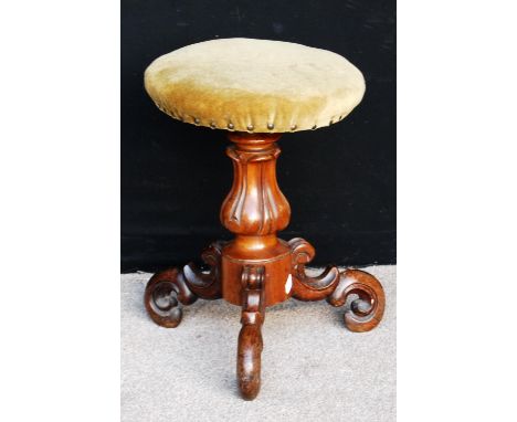 Victorian rosewood adjustable piano stool, the circular cushioned seat raised on baluster column and scroll tripod legs, 50cm