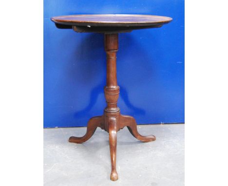 19th century mahogany tilt top table, the circular top with rim raised on urn turned column, tripod cabriole legs terminating