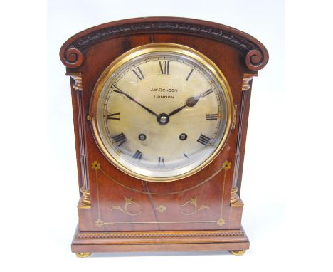 Mahogany cased bracket clock by J.W. Benson, London with arched pediment, circular brass face, Roman numerals flanked by flut