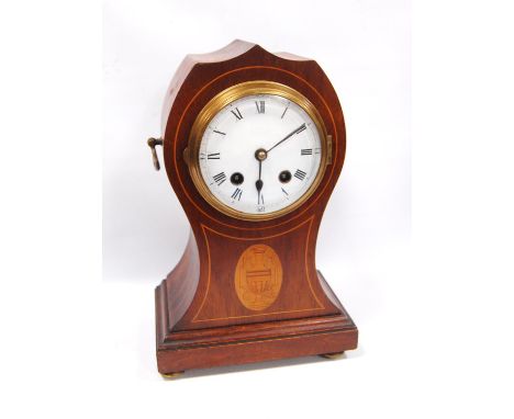 Mahogany mantel clock with enamelled circular face, Roman numerals, boxwood inlaid trunk with urn lozenge, raised on bun feet