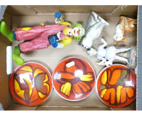 A mixed collection of items to include three Poole pottery pin dishes, Goebel Happy Clown, Beswick ginger cat, Continental fi