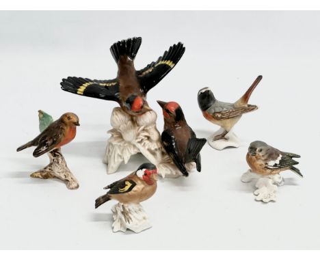 A collection of Goebel pottery birds. 