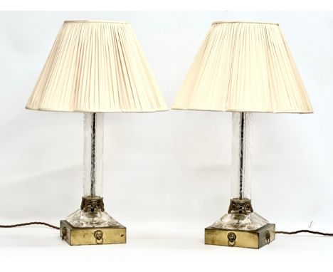 A pair of large table lamps with etched glass columns on brass bases and lion mask rings. 18x18x53cm without shades. 70cm wit