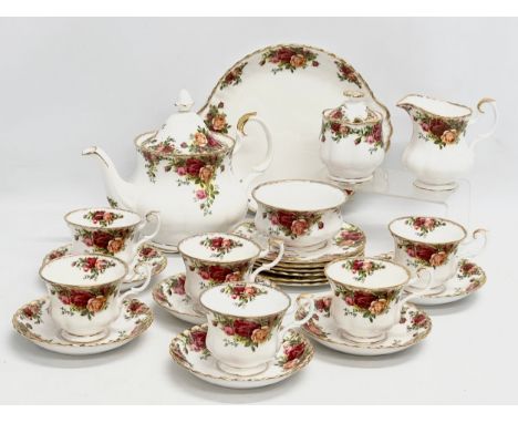 A 23 piece Royal Albert ‘Old Country Roses’ tea service. Teapot, 2 sugar bowls, milk jug, cake plate, 6 sandwich plates, 6 te
