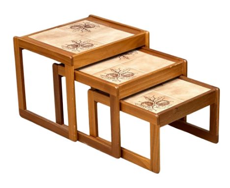 A Mid Century teak nest of tables with tile top.   10 