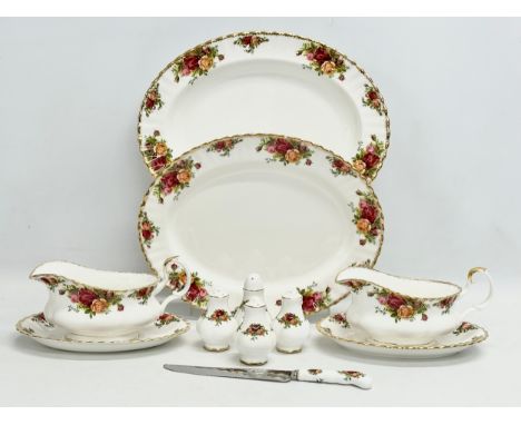 A quantity of Royal Albert ‘Old Country Roses’ dinner ware. 2 platters, 2 gravy boats and saucers, salt and pepper shakers, s
