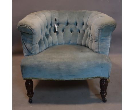 A Victorian mahogany tub chair, with blue button back velour upholstery, raised on turned legs and castors 